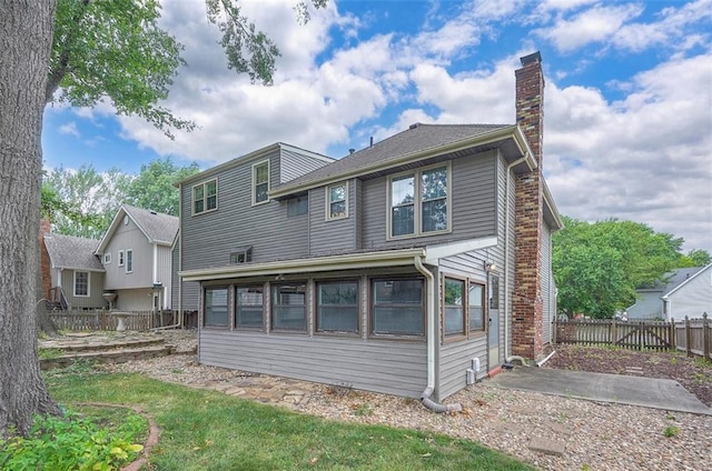 16327 W Locust St, Olathe, KS 66062 - back of house with a chimney and a patio