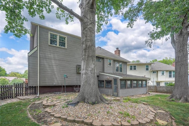 16327 W Locust St, Olathe, KS 66062 - rear view of house with a sunroom and a chimney