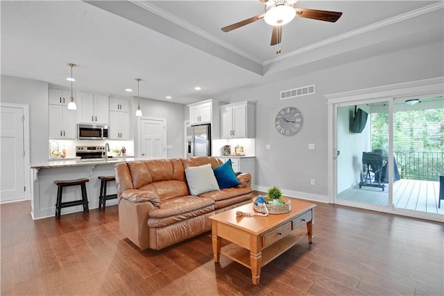 23103 W 125th Ter, Olathe, KS 66016 - living area featuring a ceiling fan, dark wood finished floors, recessed lighting, and ornamental molding