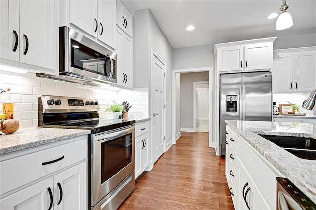23103 W 125th Ter, Olathe, KS 66016 - kitchen featuring stainless steel appliances, white cabinets, tasteful backsplash, and recessed lighting