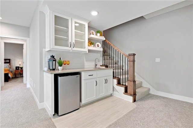 23103 W 125th Ter, Olathe, KS 66016 - indoor wet bar featuring refrigerator, light colored carpet, decorative backsplash, stairway, and recessed lighting