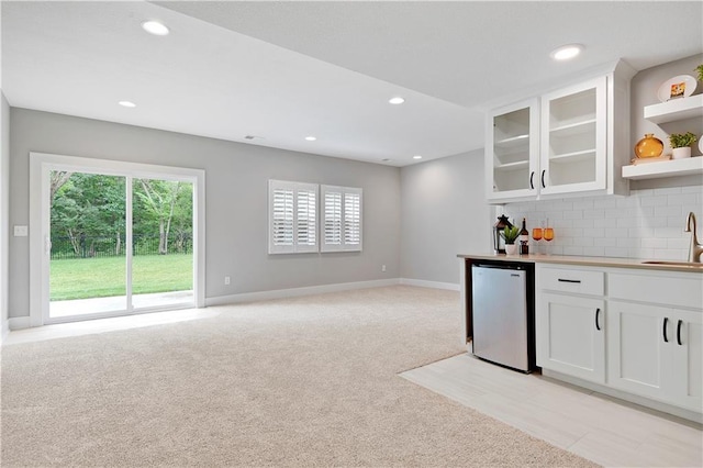 23103 W 125th Ter, Olathe, KS 66016 - kitchen featuring open shelves, light colored carpet, white cabinets, glass insert cabinets, and decorative backsplash