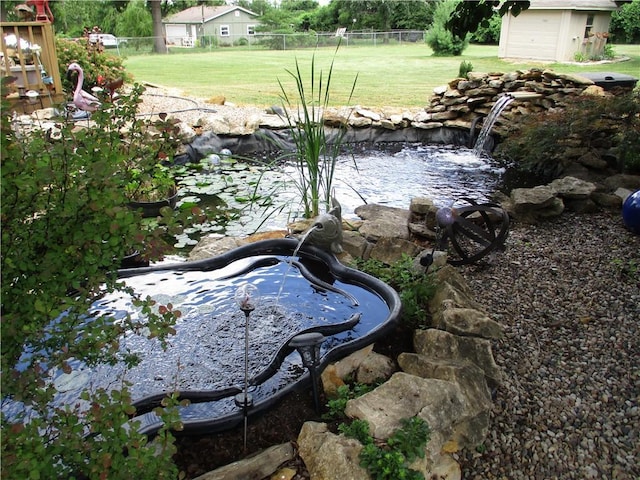 8265 Gleason Rd, Lenexa, KS 66227 - view of yard with a garden pond and an outbuilding