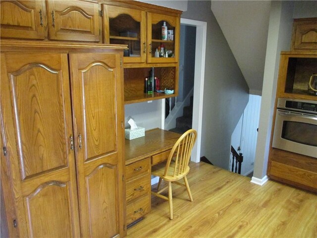 8265 Gleason Rd, Lenexa, KS 66227 - office featuring light wood finished floors, built in desk, and vaulted ceiling