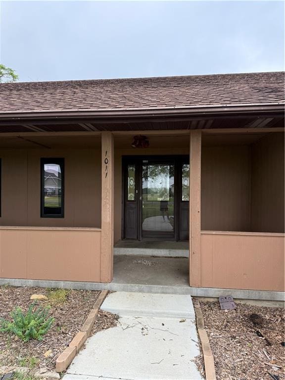 1011 N Arrowhead Dr, Burlington, KS 66839 - doorway to property featuring roof with shingles and a porch