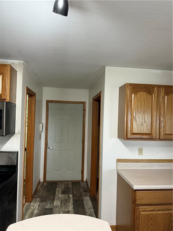 1011 N Arrowhead Dr, Burlington, KS 66839 - kitchen featuring dark wood finished floors, brown cabinetry, and light countertops