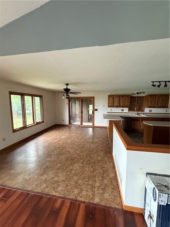 1011 N Arrowhead Dr, Burlington, KS 66839 - kitchen with dark wood-style flooring, ceiling fan, open floor plan, and a kitchen island