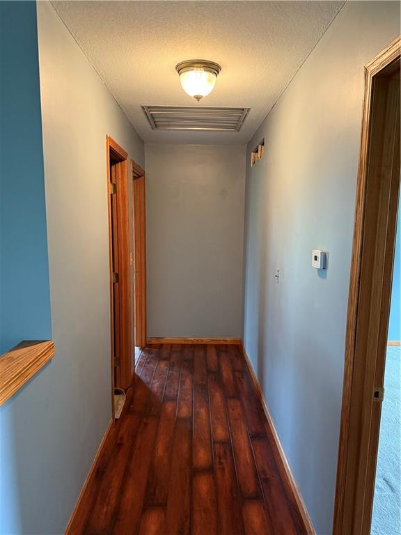 1011 N Arrowhead Dr, Burlington, KS 66839 - hall featuring wood-type flooring and a textured ceiling