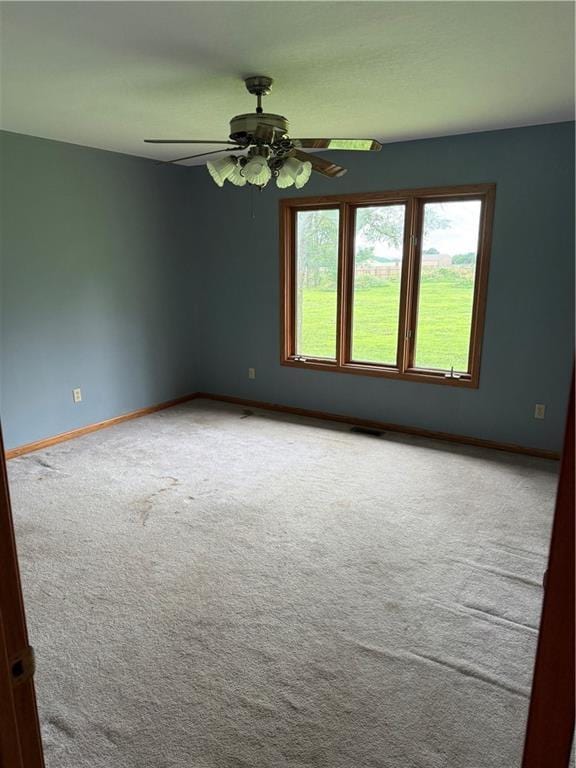 1011 N Arrowhead Dr, Burlington, KS 66839 - carpeted spare room with ceiling fan and baseboards