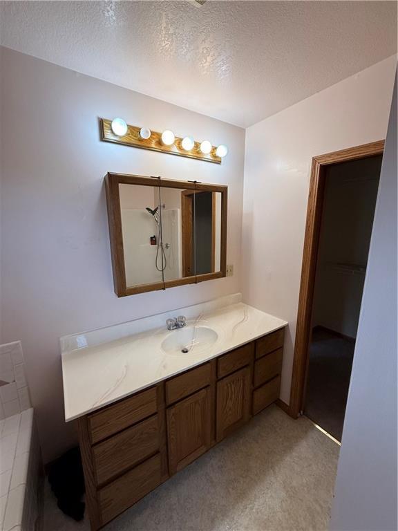 1011 N Arrowhead Dr, Burlington, KS 66839 - full bathroom featuring vanity and a textured ceiling