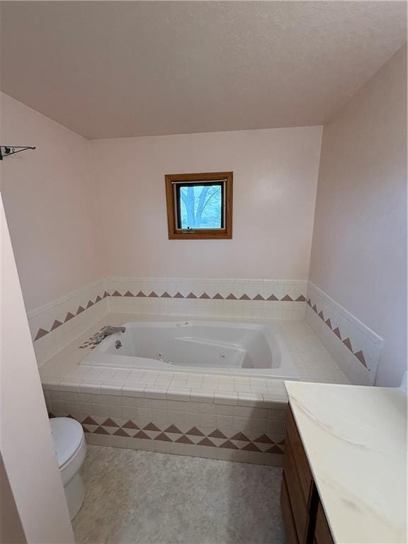 1011 N Arrowhead Dr, Burlington, KS 66839 - bathroom with vanity, a tub with jets, and tile patterned flooring