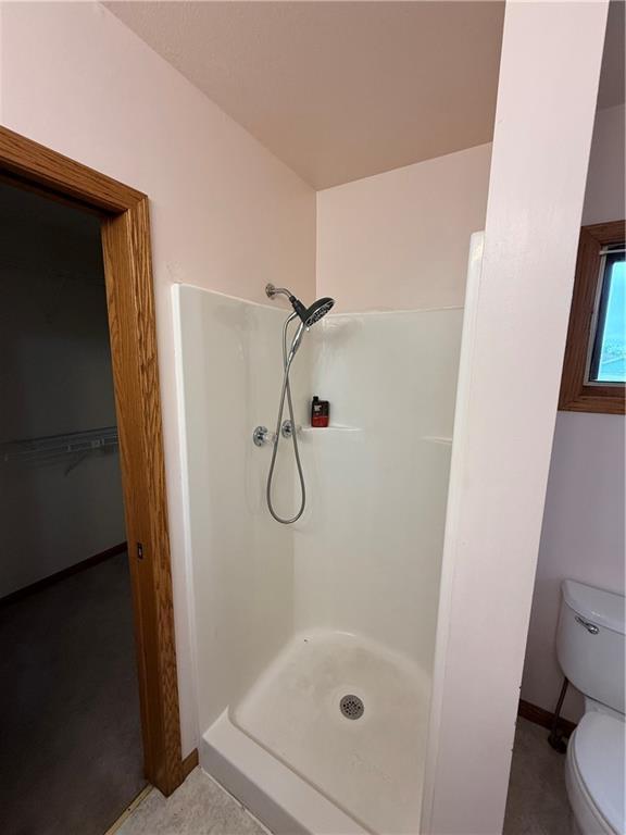 1011 N Arrowhead Dr, Burlington, KS 66839 - bathroom featuring a shower stall and a walk in closet