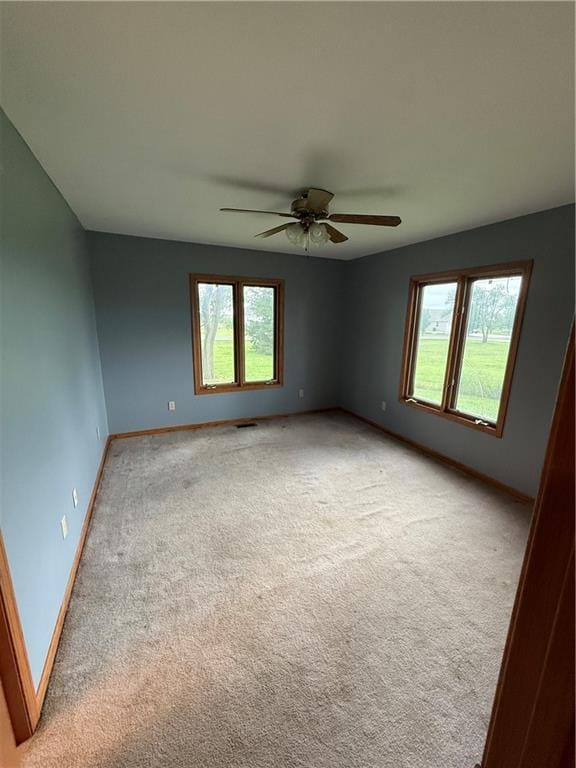 1011 N Arrowhead Dr, Burlington, KS 66839 - spare room with light carpet and ceiling fan