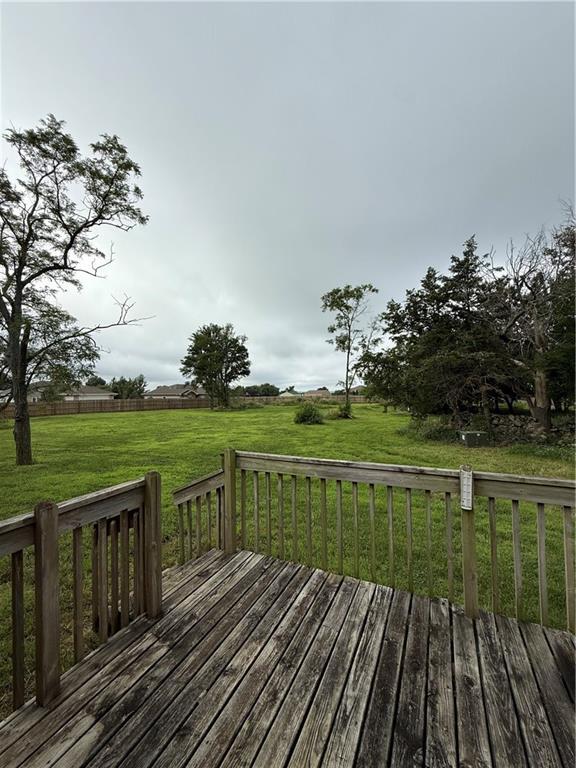 1011 N Arrowhead Dr, Burlington, KS 66839 - wooden deck featuring a lawn