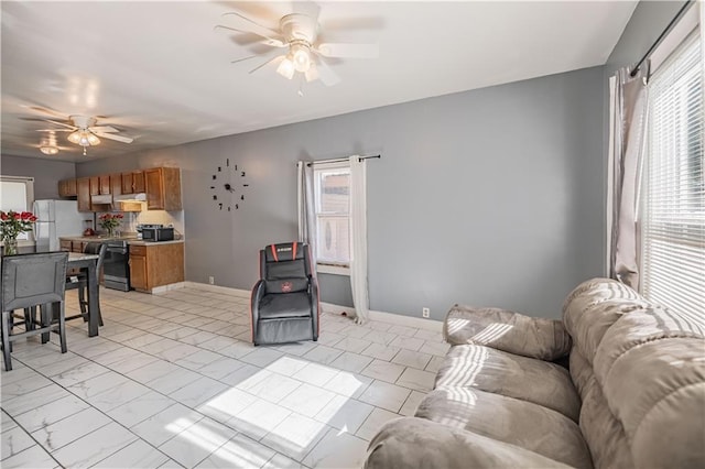 321 Oakley Ave, Kansas City, MO 64123 - living room featuring ceiling fan and light marble finish flooring