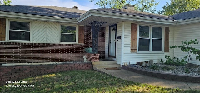 4501 E 105th St, Kansas City, MO 64137 - entrance to property featuring roof with shingles and brick siding