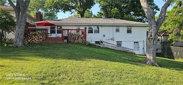 4501 E 105th St, Kansas City, MO 64137 - back of property featuring a lawn, a wooden deck, a chimney, and stairway