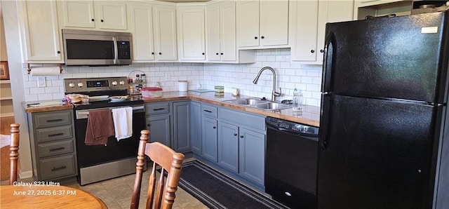 4501 E 105th St, Kansas City, MO 64137 - kitchen with black appliances, decorative backsplash, light countertops, and white cabinets