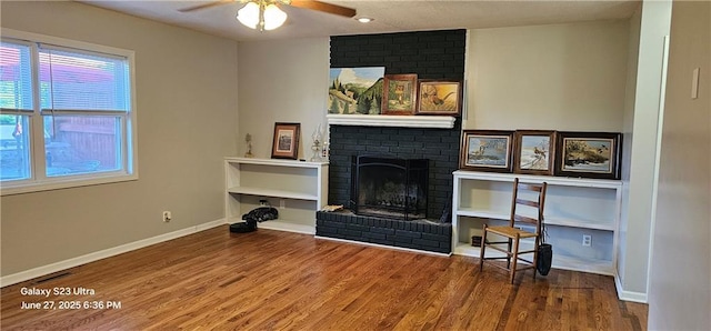 4501 E 105th St, Kansas City, MO 64137 - living area featuring ceiling fan, wood finished floors, and a fireplace