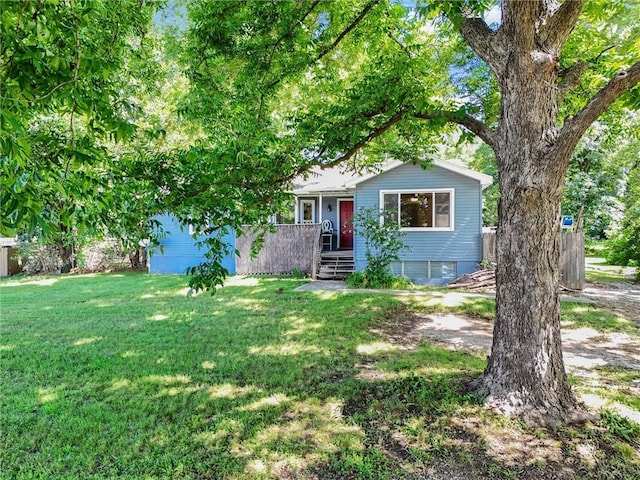 16128 Midland Dr, Shawnee, KS 66217 - view of property hidden behind natural elements featuring a front yard