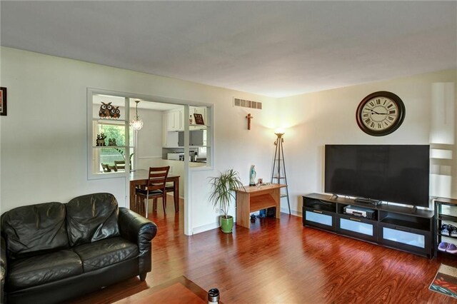 16128 Midland Dr, Shawnee, KS 66217 - living room with wood finished floors and a chandelier