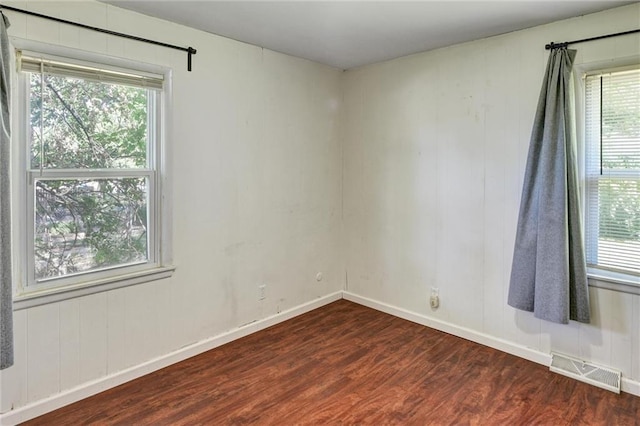 16128 Midland Dr, Shawnee, KS 66217 - empty room featuring dark wood-style flooring and baseboards