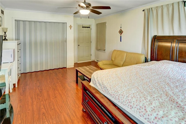 16128 Midland Dr, Shawnee, KS 66217 - bedroom with wood finished floors, ornamental molding, a closet, and ceiling fan