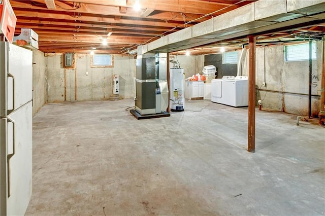 16128 Midland Dr, Shawnee, KS 66217 - basement featuring water heater, heating unit, washer and clothes dryer, freestanding refrigerator, and plenty of natural light