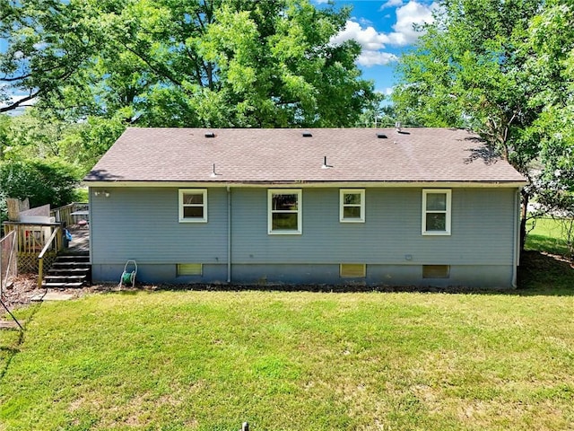 16128 Midland Dr, Shawnee, KS 66217 - rear view of house featuring roof with shingles, a deck, and a yard