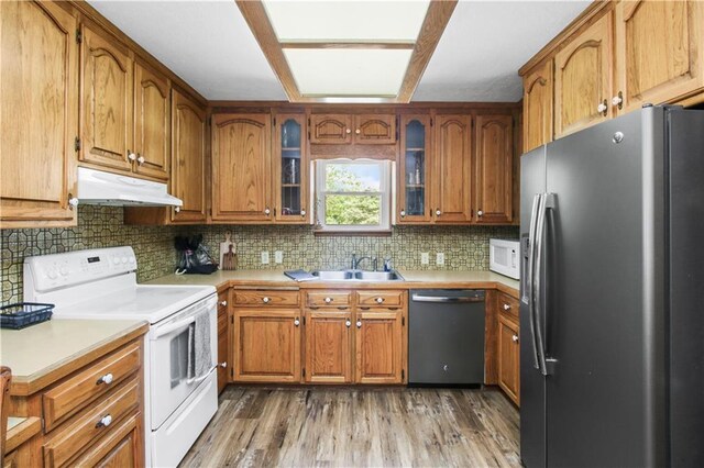 38410 E Cline Rd, Lone Jack, MO 64070 - kitchen with stainless steel appliances, under cabinet range hood, brown cabinets, and light countertops