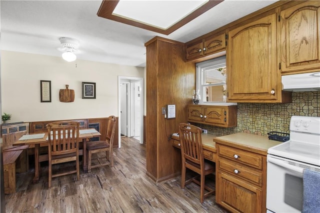 38410 E Cline Rd, Lone Jack, MO 64070 - kitchen with white electric stove, decorative backsplash, a ceiling fan, dark wood-style flooring, and brown cabinets