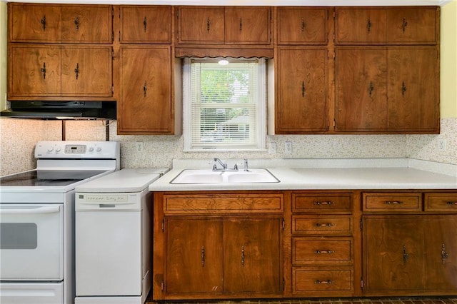 2731 S Northern Blvd, Independence, MO 64052 - kitchen featuring white appliances, under cabinet range hood, light countertops, and brown cabinetry