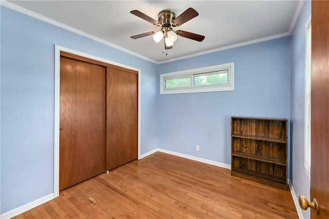 2731 S Northern Blvd, Independence, MO 64052 - unfurnished bedroom with wood finished floors, a closet, ornamental molding, and ceiling fan