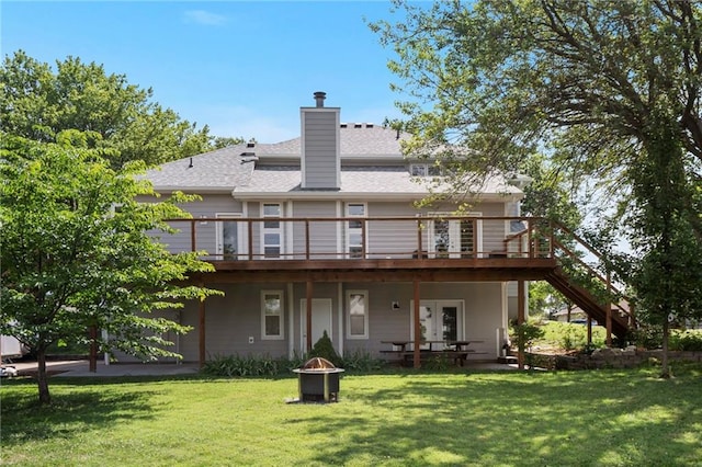 200 S Park Dr, Raymore, MO 64083 - back of property featuring a fire pit, a wooden deck, stairs, and a yard