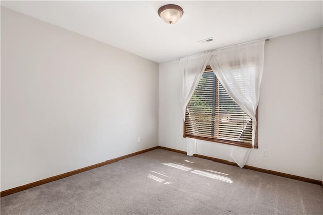 200 S Park Dr, Raymore, MO 64083 - spare room featuring carpet and baseboards
