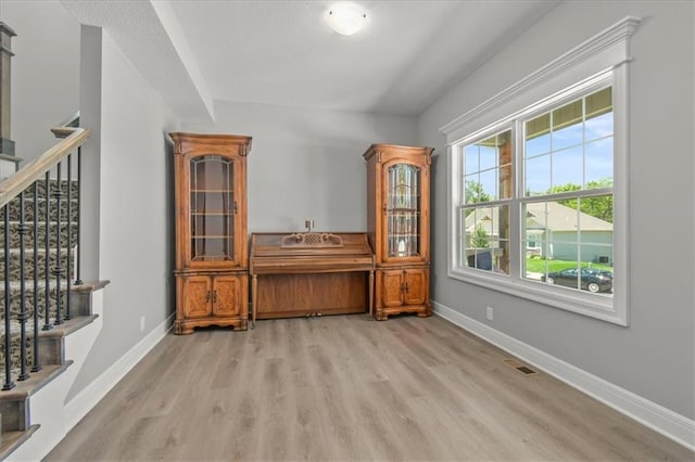 801 NW Hickory Ridge Dr, Grain Valley, MO 64029 - bar featuring light wood-type flooring and stairway