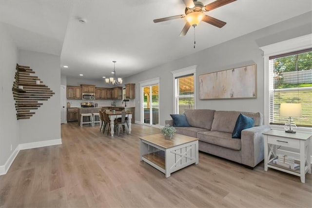 801 NW Hickory Ridge Dr, Grain Valley, MO 64029 - living area with light wood-style floors, ceiling fan, a chandelier, recessed lighting, and stairs