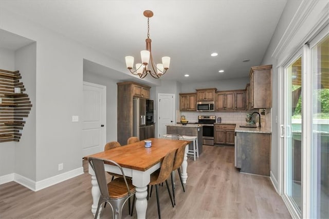 801 NW Hickory Ridge Dr, Grain Valley, MO 64029 - dining room featuring a chandelier, light wood-type flooring, and recessed lighting