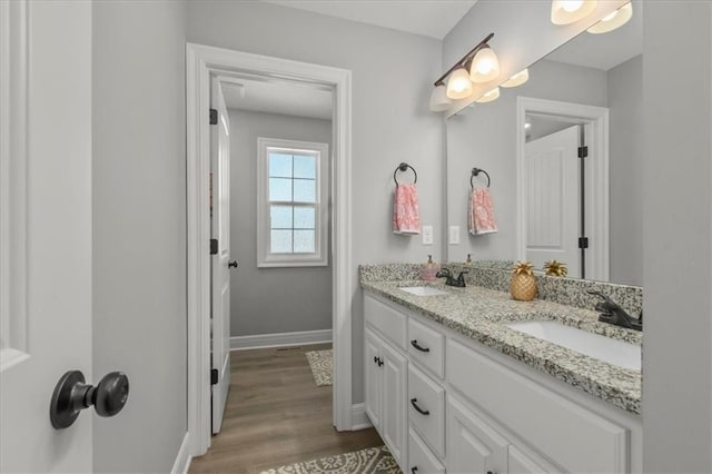 801 NW Hickory Ridge Dr, Grain Valley, MO 64029 - bathroom with double vanity and wood finished floors