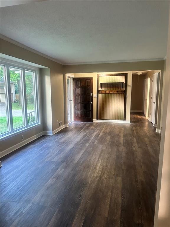 12621 E 41st Ter S, Independence, MO 64055 - unfurnished living room featuring ornamental molding and dark wood-style flooring