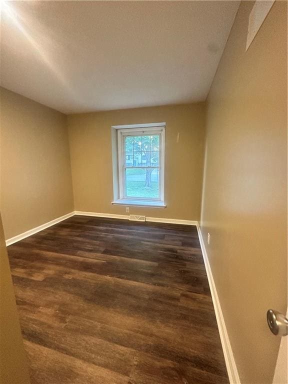 12621 E 41st Ter S, Independence, MO 64055 - spare room with dark wood-type flooring and baseboards