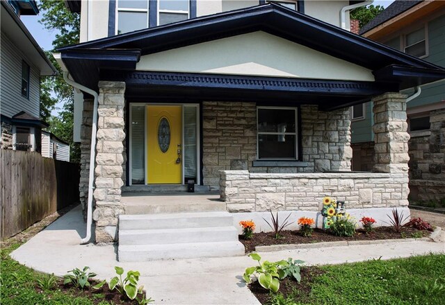 3635 Wabash Ave, Kansas City, MO 64109 - property entrance with stone siding, covered porch, and stucco siding