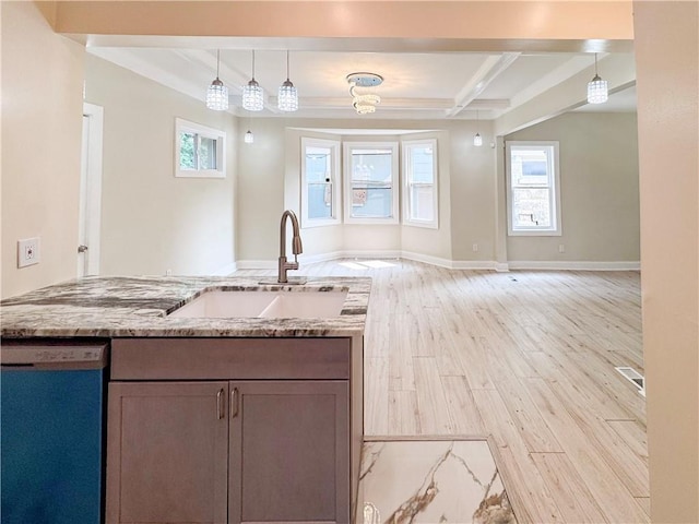 3635 Wabash Ave, Kansas City, MO 64109 - kitchen with dishwasher, light wood finished floors, light stone countertops, open floor plan, and decorative light fixtures