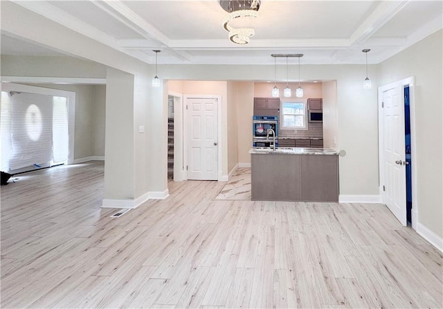 3635 Wabash Ave, Kansas City, MO 64109 - kitchen with light wood-style floors, coffered ceiling, beam ceiling, open floor plan, and a peninsula