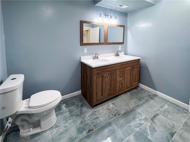 3635 Wabash Ave, Kansas City, MO 64109 - bathroom with double vanity and marble look tile flooring