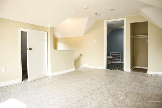 3635 Wabash Ave, Kansas City, MO 64109 - unfurnished living room featuring carpet flooring and vaulted ceiling