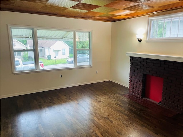 812 N 9th St, Leavenworth, KS 66048 - unfurnished living room with a brick fireplace and wood finished floors