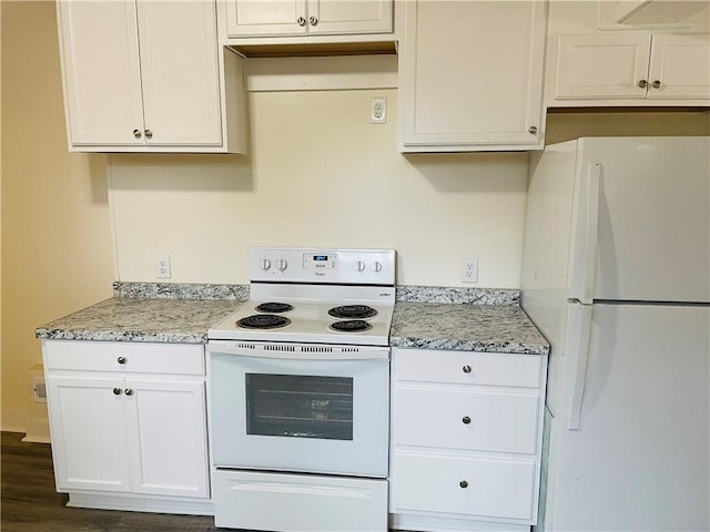 812 N 9th St, Leavenworth, KS 66048 - kitchen featuring white appliances, white cabinets, dark wood-type flooring, and light stone counters