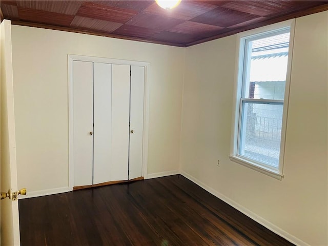 812 N 9th St, Leavenworth, KS 66048 - unfurnished bedroom featuring dark wood-style flooring, wood ceiling, and a closet