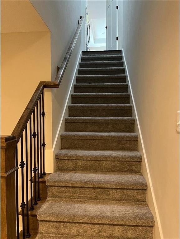 15653 Lakeside Dr, Basehor, KS 66007 - staircase featuring wood finished floors and a high ceiling